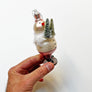 Snowman Holding Trees in Front Glass Ornament