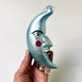 Rosy Cheek Crescent Moon Man Blue Glass Ornament