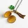 PATCH NYC Treasure Necklace: Vintage Gold Tone Locket with Tassel & Lucky Clover
